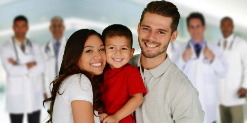 Family Smiling and Standing in Front of Doctors