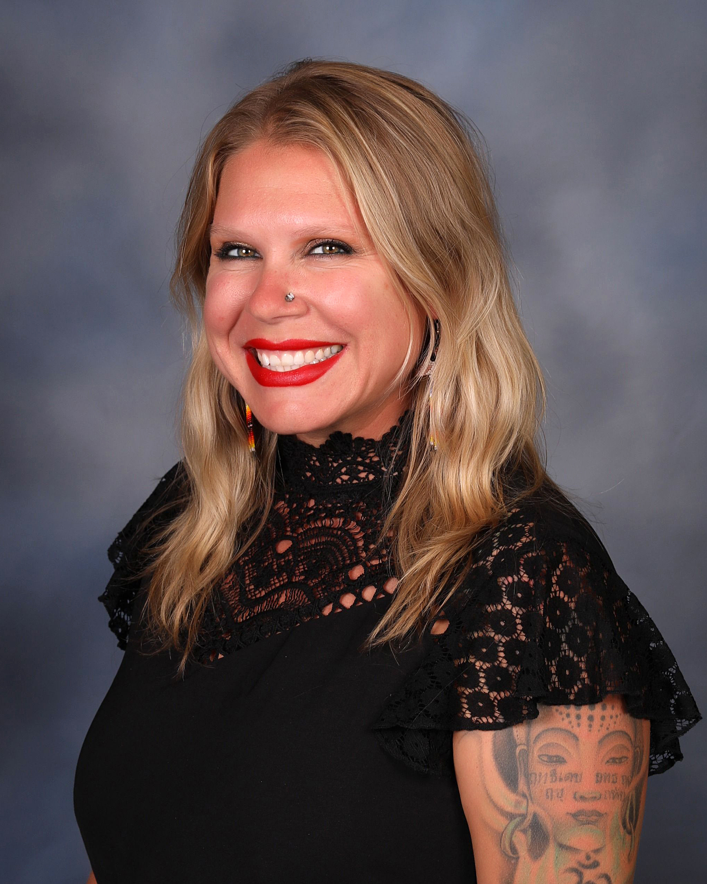 individual with wavy hair with a black top 